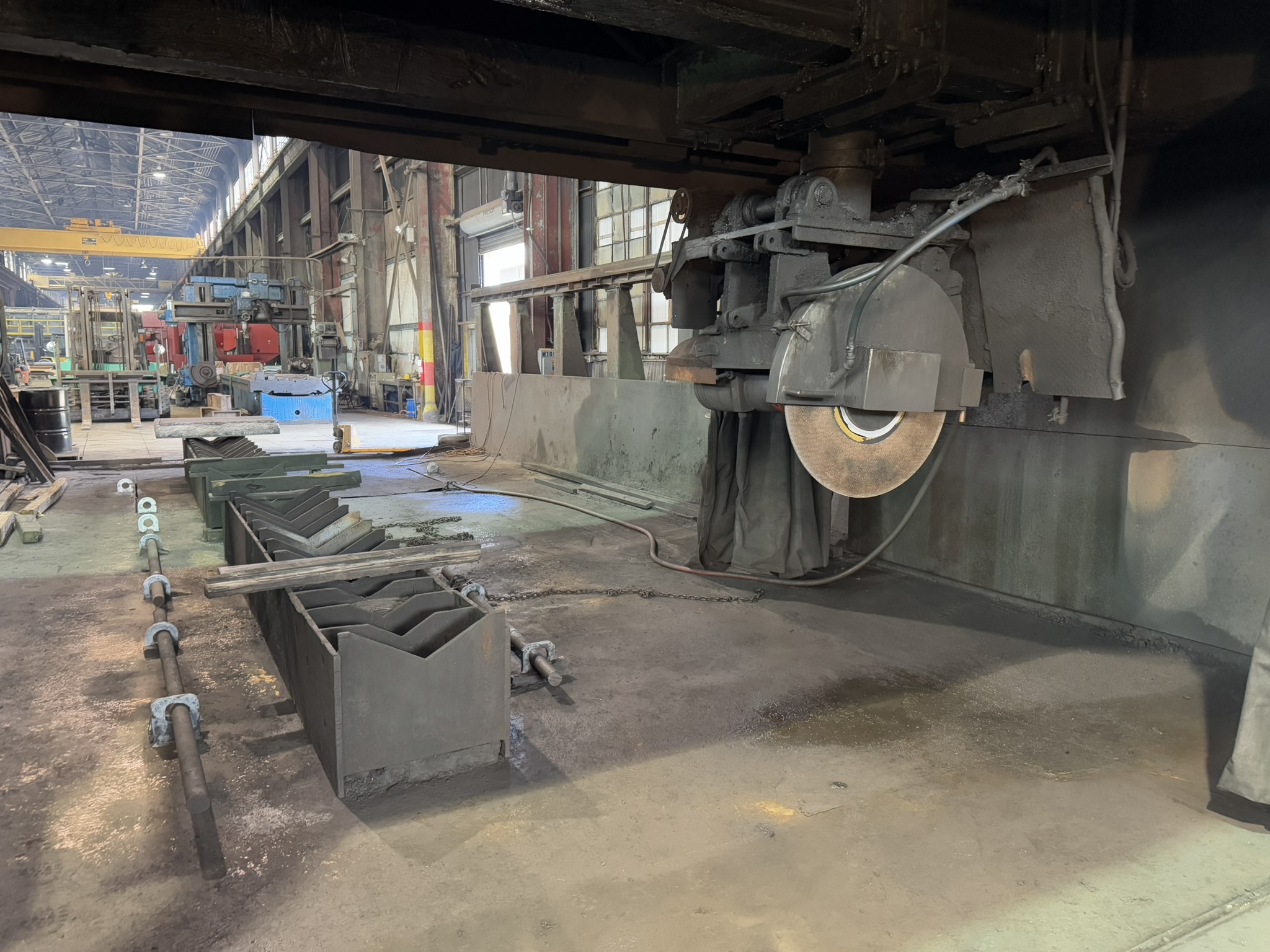 Bandsaw cutting through titanium billet at MSI Corporation