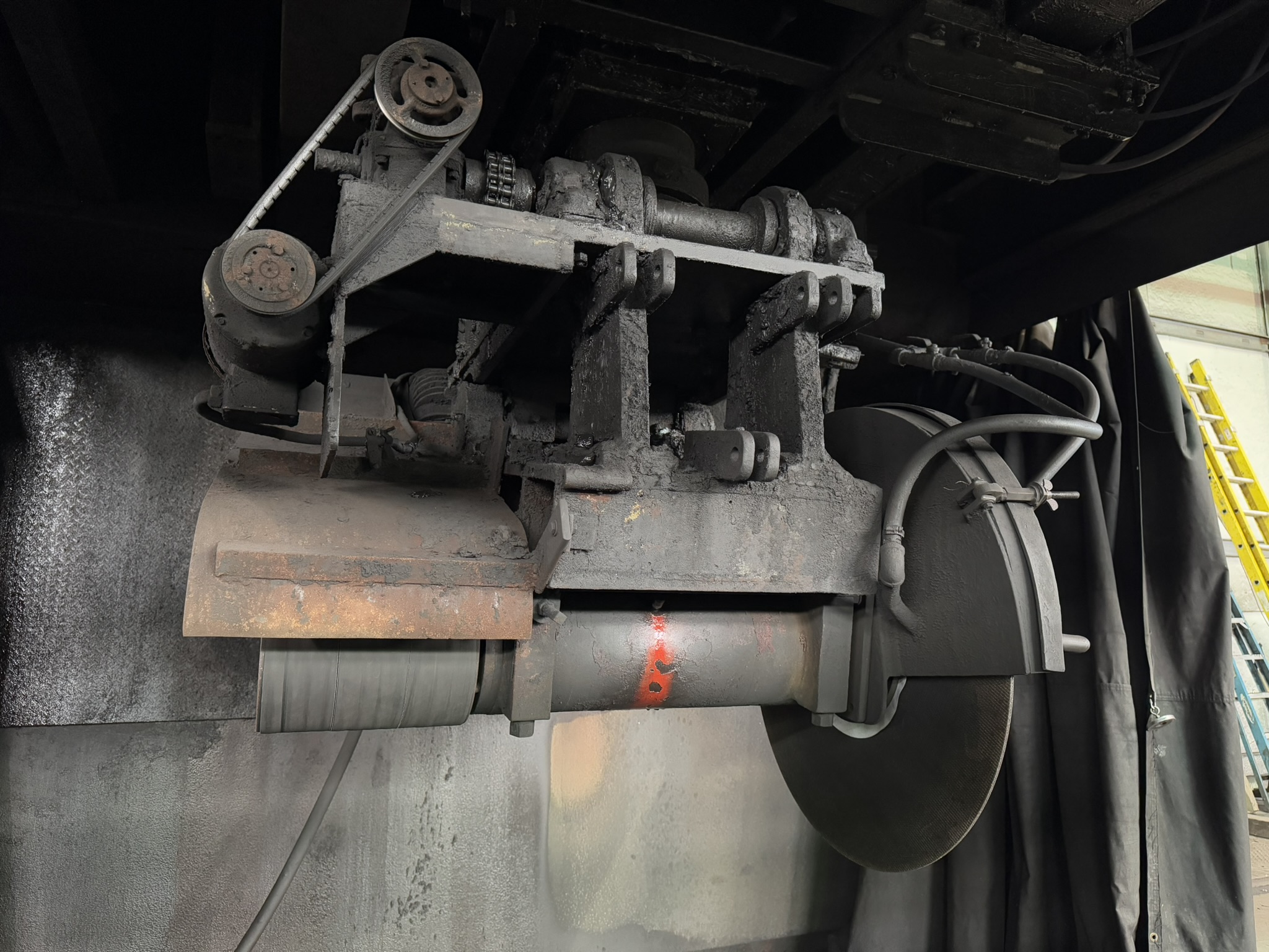 Bandsaw cutting through titanium billet at MSI Corporation
