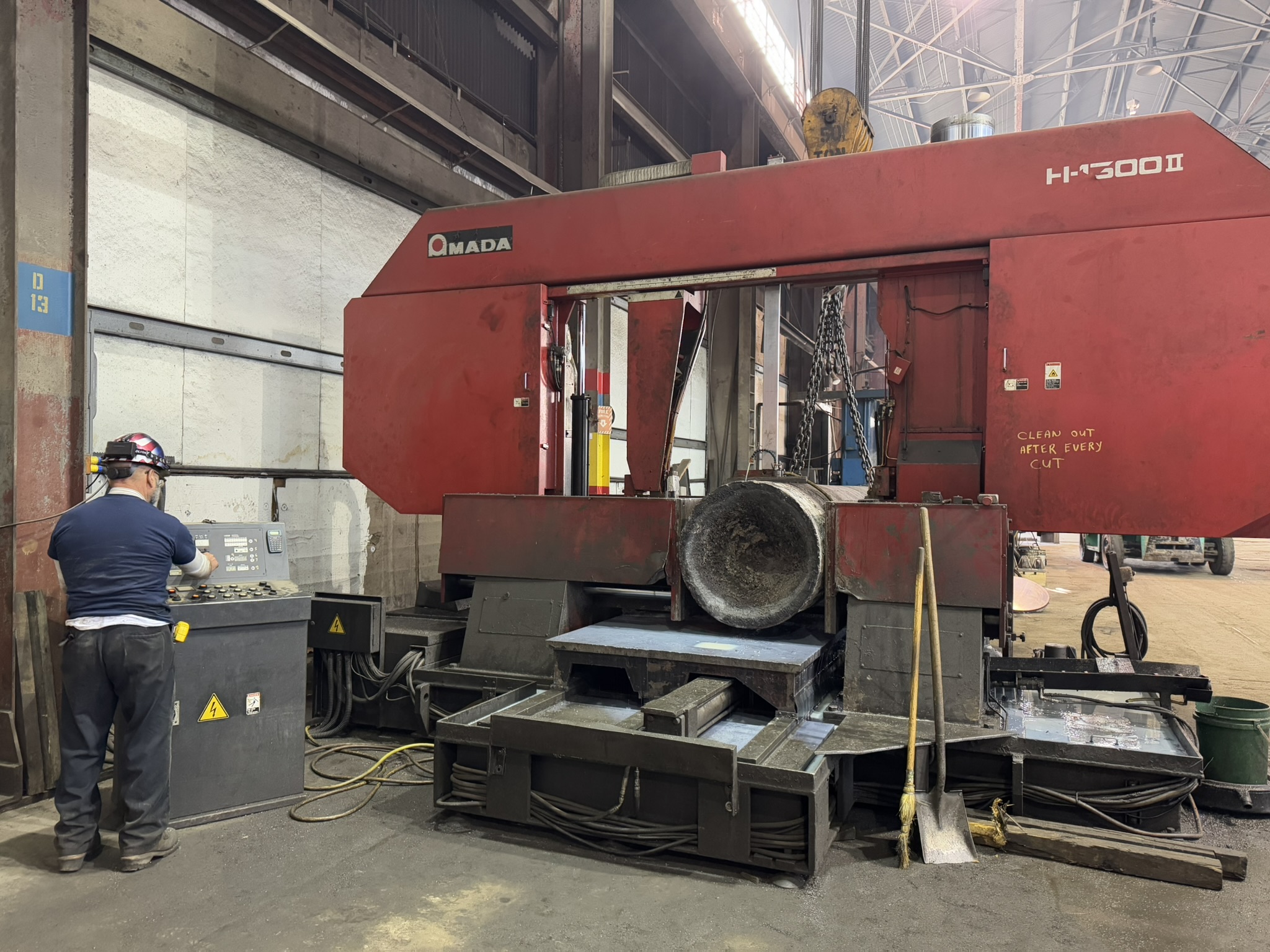 Bandsaw cutting through titanium billet at MSI Corporation
