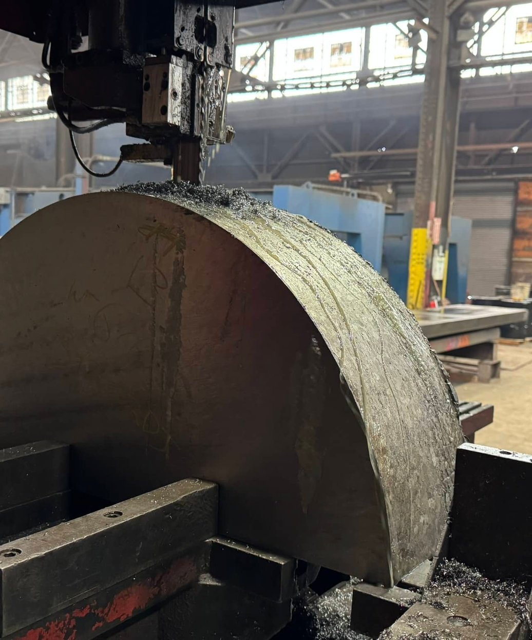 Bandsaw cutting through titanium billet at MSI Corporation