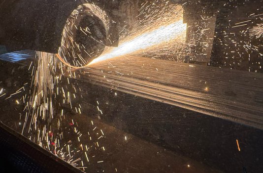 Sparks from Midwest wheel grinding a slab