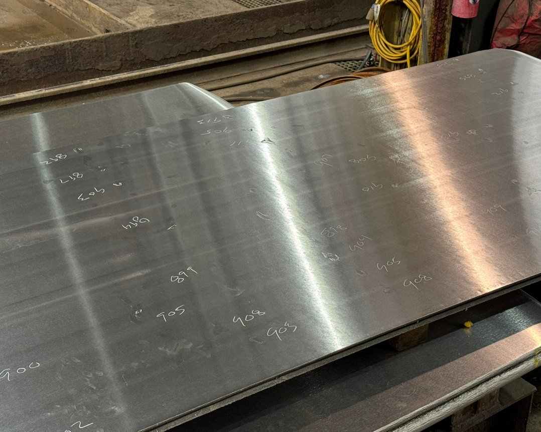 Ground titanium plate with thickness measurements marked